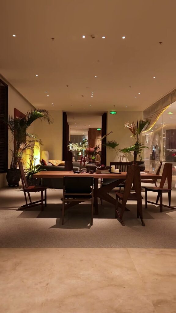 Still from the KBH film: Warm light, a wood table, and greenery